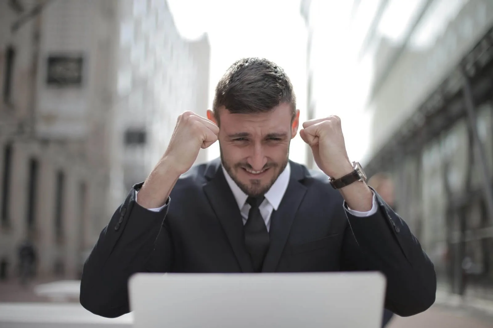 A business man cheering due to his success.