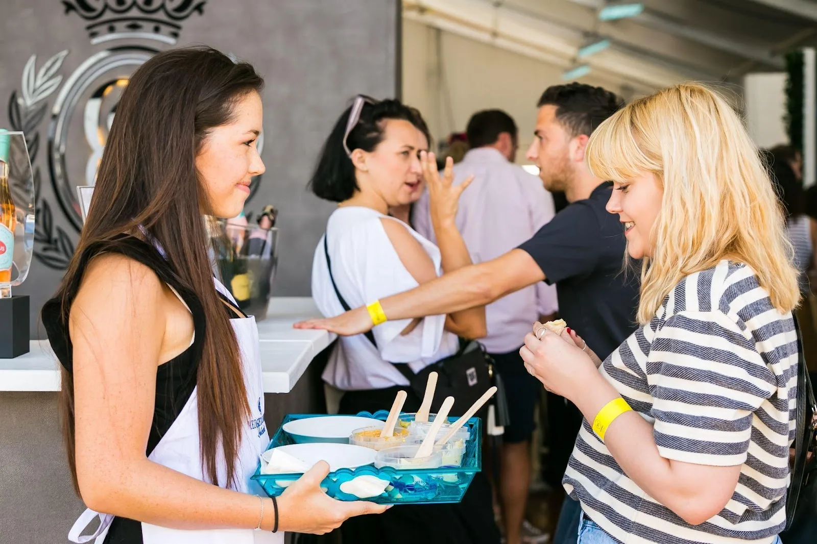 An employee of a business handing out samples to consumers at events