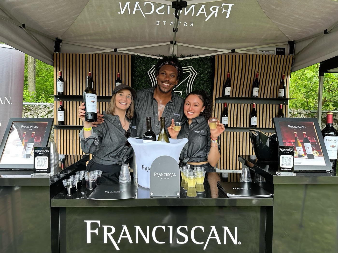 Brand ambassadors pouring wine samples at a Franciscan Estate brand activation tent