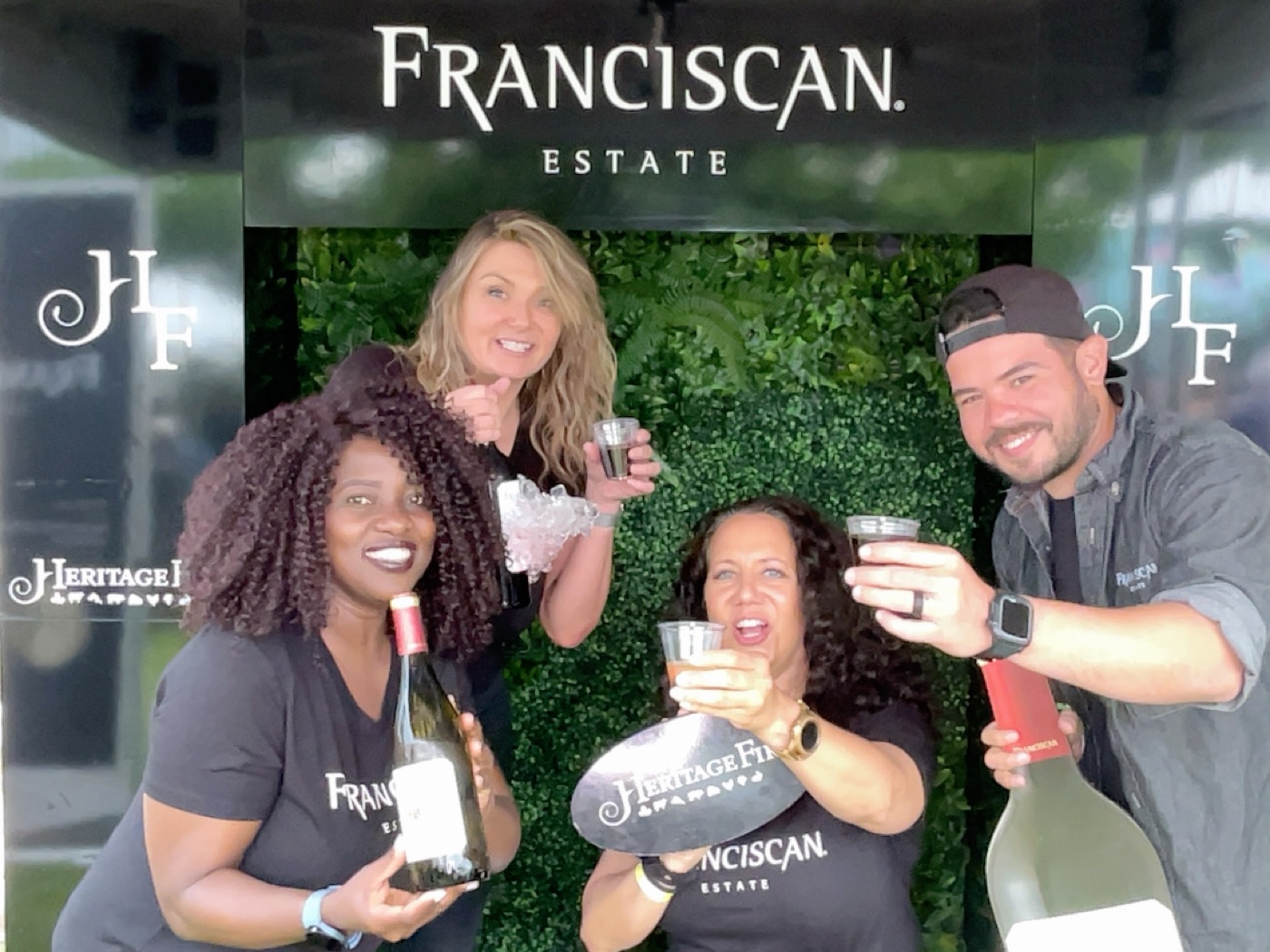 A Little Bird team celebrating with wine at the Franciscan Estate x Heritage Fire Festival brand engagement tour