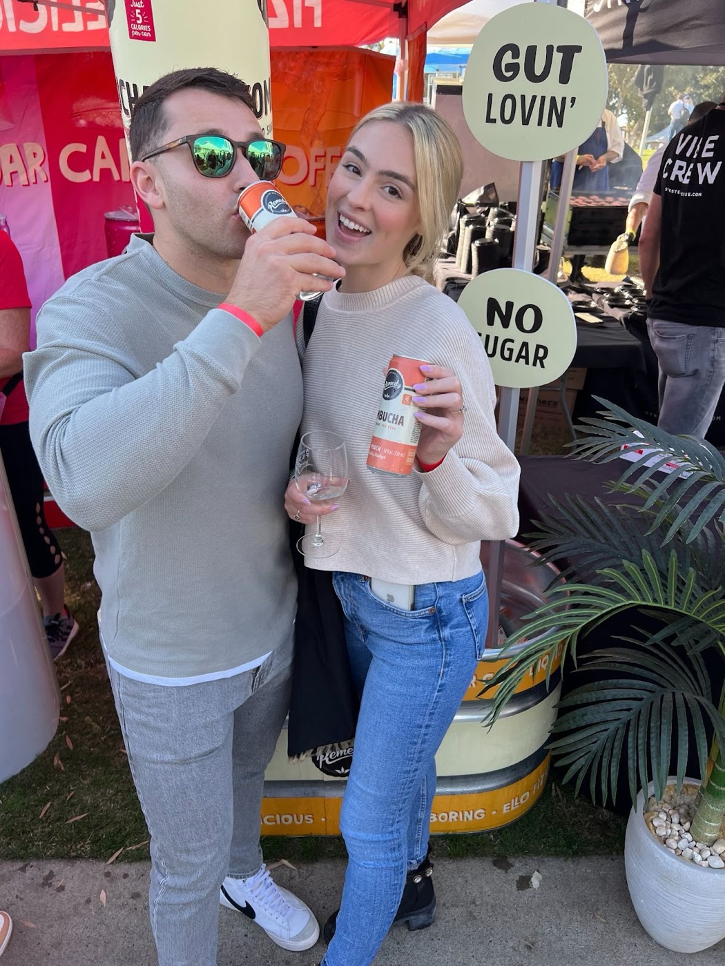 Couple sampling Remedy Kombucha together at a branded outdoor engagement activation