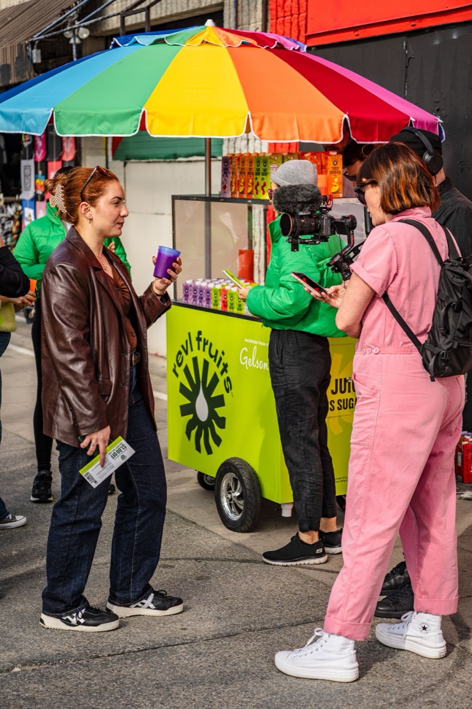 Content creators filming a street sampling activation with a colorful branded cart