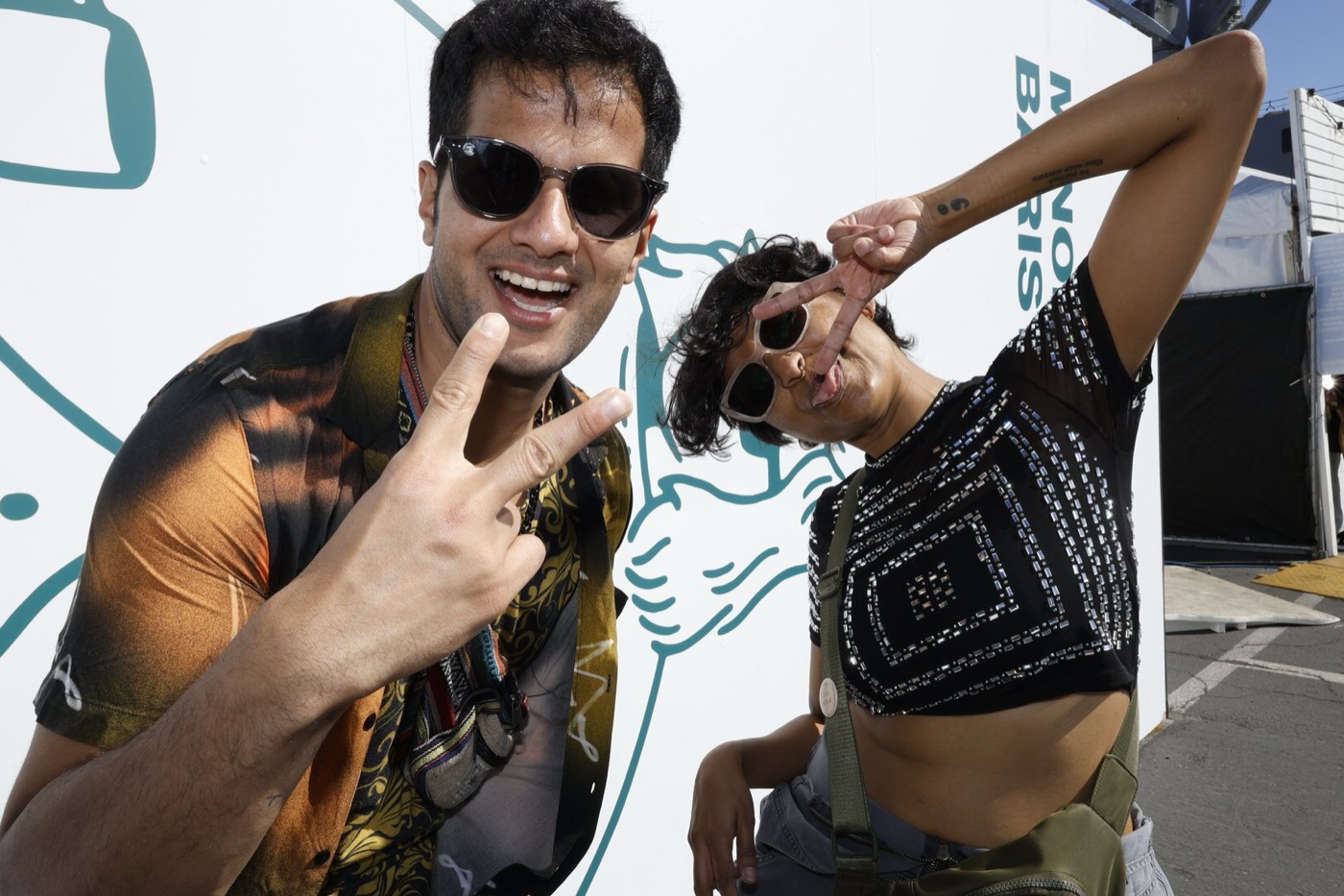 Friends taking a branded selfie at an outdoor festival activation