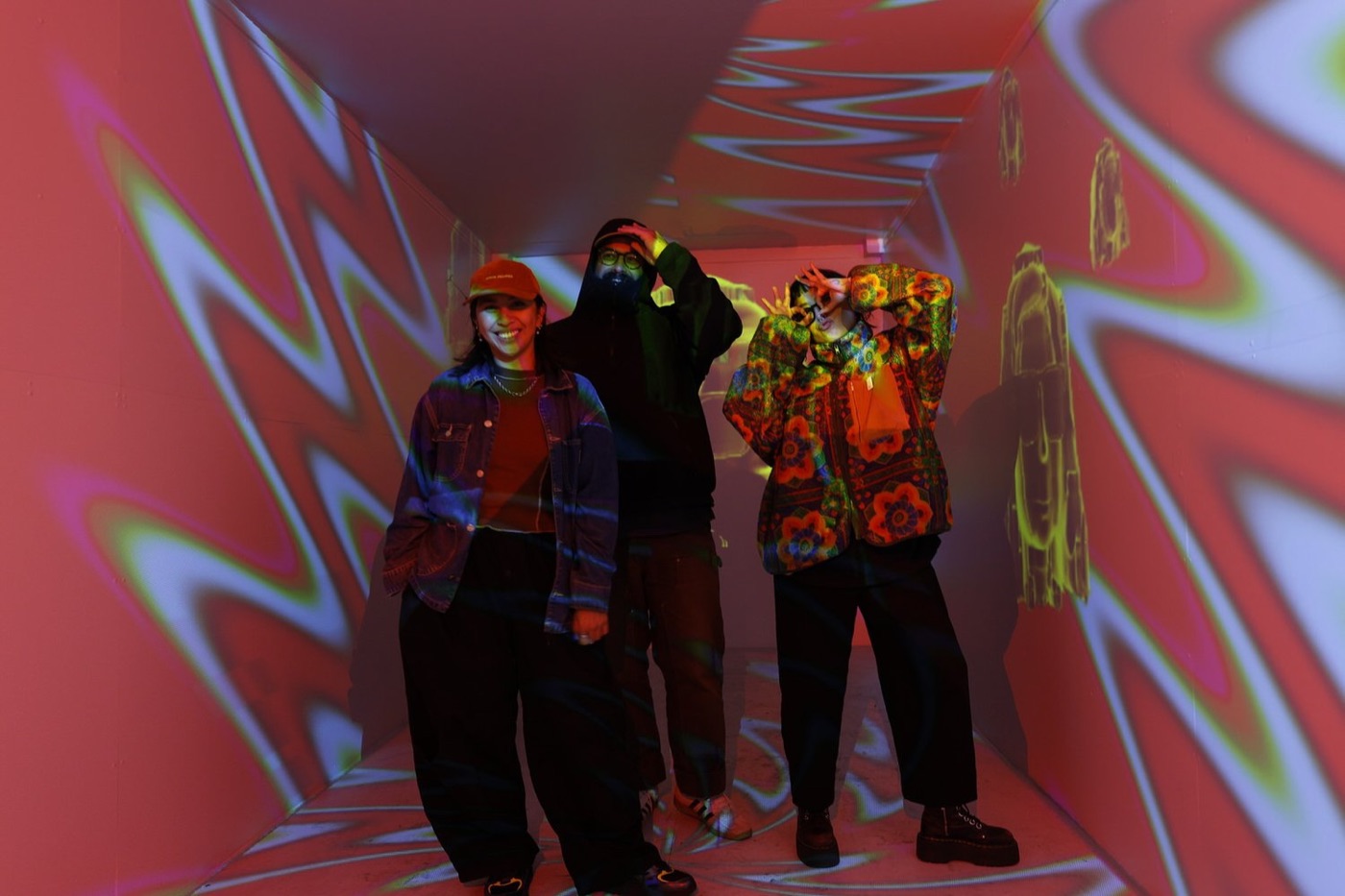 Friends posing inside a colorful immersive light installation at a branded social media activation