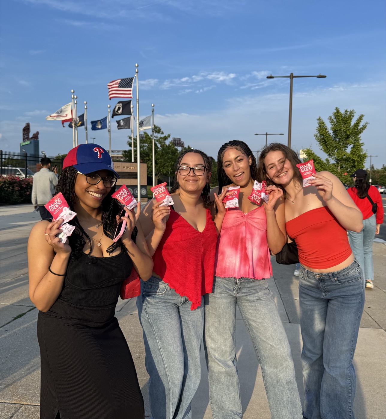 Brand ambassadors sampling MadeGood snacks with fans outside a stadium as part of a social advertising and community campaign